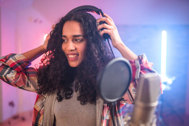 istock Young Hispanic Beautiful Woman Singing in Recording Studio 1438260412