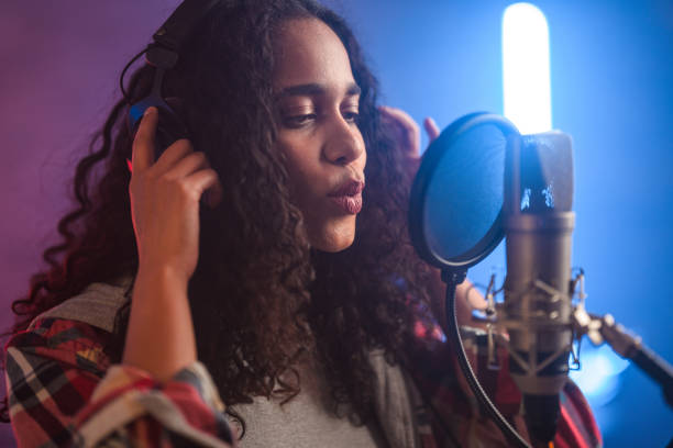 istock Young Hispanic Beautiful Woman Singing in Recording Studio 1438260423