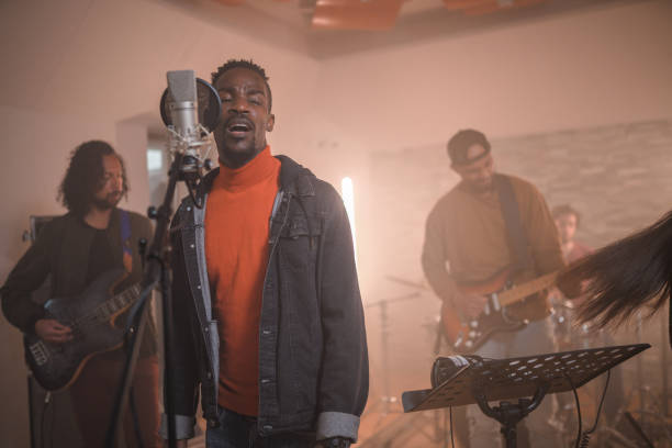 istock Multi-Ethnic Music Group recording Songs In Music Recording Studio 1438260426