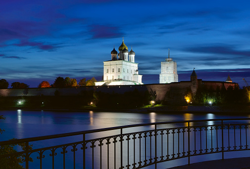 The Old Russian Pskov Kremlin. Trinity Cathedral behind the fortress walls at night. Pskov, Russia, 2022