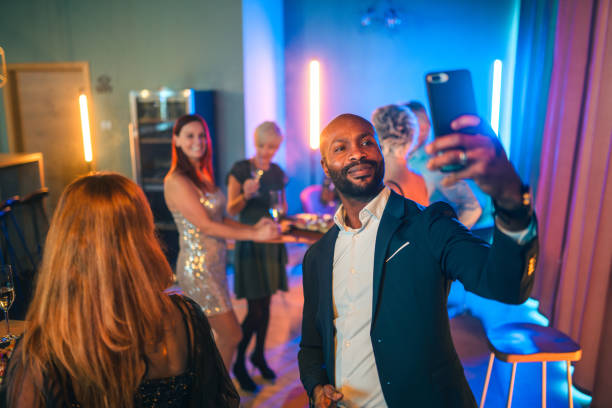 istock Well-dressed Man Taking A Selfie Picture At A Party 1438261816