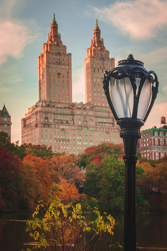 Central Park in Fall with towers on Central Park West. Classic Central Park lantern in the foreground