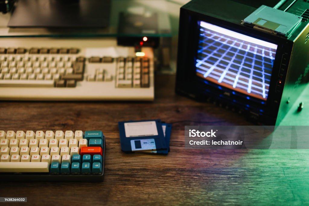 mechanical keyboard and floppy disks Retrofuturistic design station for creating pixel art and synth wave music. Coding Stock Photo