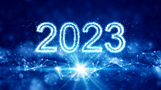 Happy New Year. The number 2023 stands out in the center of the image on a dark blue background with interconnected polygons, bokeh particles and light. stock photo