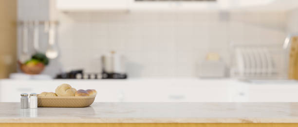 istock White kitchen countertop with copy space over blurred modern white and clean kitchen 1438266616