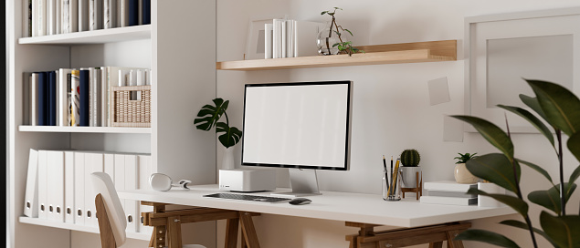 Minimal Scandinavian white home office workspace interior design with modern pc computer mockup on table, white bookcase, chair, home decor, white wall and indoor plants. 3d render, 3d illustration