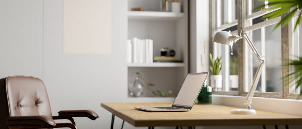 istock side view. Modern minimal bright office workspace with laptop mockup on wooden desk 1438266641