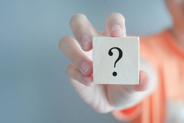 istock Hand holding question mark symbol on wooden block with copy space. Ask, FAQ, Advice, Support, Problem and solution concept. 1438266695