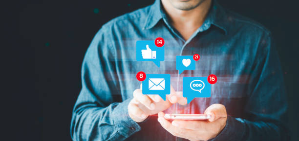 istock Men hand using smartphones type Live chat and social network chatting conversation working at home in chat box icons pop up, Social media marketing Technology business and social lifestyle concept. 1438266740