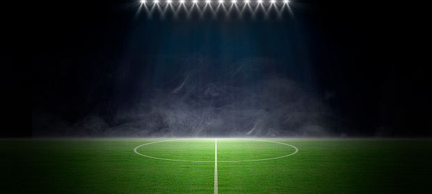 A sports stadium with a lights background, Textured soccer game field with spotlights fog - center, midfield Concept of sport, competition, winning, action, empty area for championships, night view