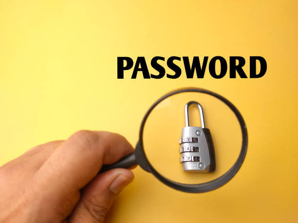 istock Hand holding magnifying glass with padlock and word PASSWORD. 1438268064