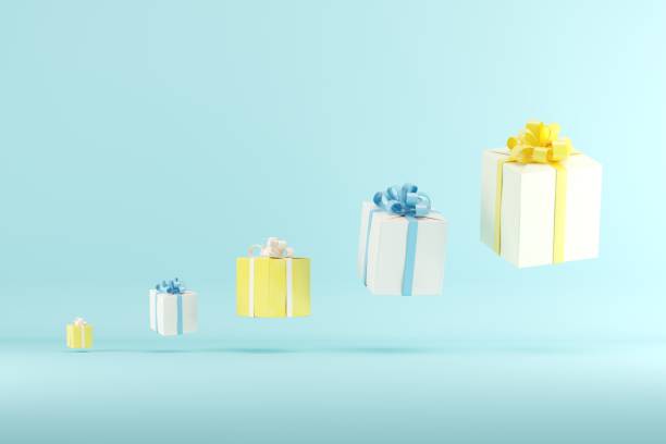 istock Outstanding Yellow Gift box among Blue Gift box Different size scale on Blue background. 3D Render. Minimal idea Christmas concept. 1438270699