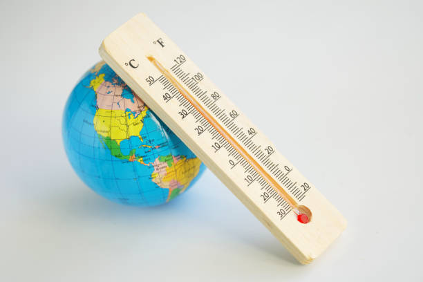 Globe and wooden eco-friendly thermometer on a white background. Temperature in Celsius and Faradays. Concept of climate change and global warming. Copy space. Selective focus. Globe and wooden eco-friendly thermometer on a white background. Temperature in Celsius and Faradays. Concept of climate change and global warming. Copy space. Selective focus. Close-up competition heat stock pictures, royalty-free photos & images