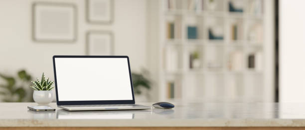 istock Modern workspace tabletop with laptop mockup over blurred office background. 1438274280