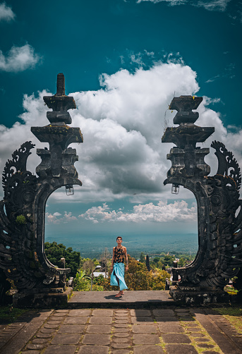 Rear view of a young man visiting Pura Besakih Temple in Bali,Indonesia .