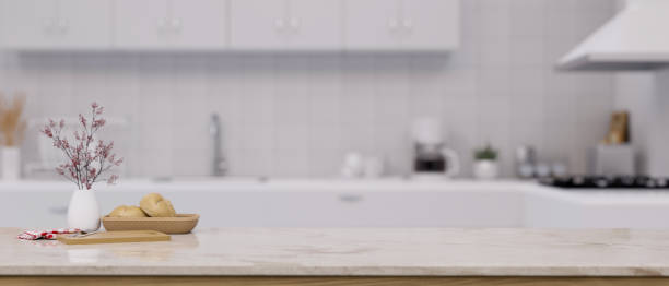 istock White marble kitchen tabletop with copy space over blurred background of modern white kitchen 1438276699