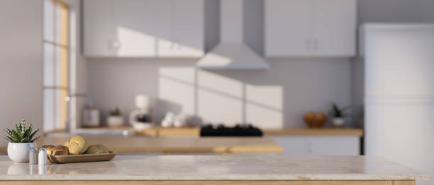 istock Stylish marble stone kitchen countertop with copy space over blurred modern kitchen 1438276710