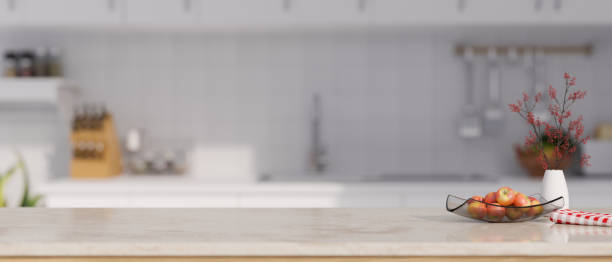 istock Marble white kitchen tabletop with apple tray, ceramic vase, napkin and copy space 1438276712