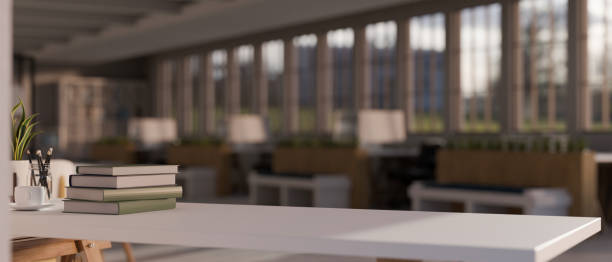 istock White tabletop with books and copy space over blurred modern reading space in library 1438276725