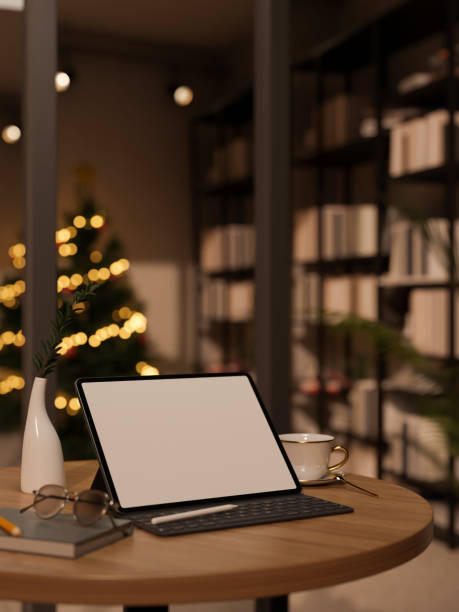 istock Tablet mockup on wood table over blurred modern living room with Christmas tree 1438277260
