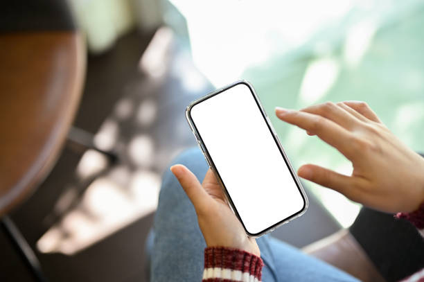 istock Female finger touching on smartphone screen. phone white screen mockup 1438278038