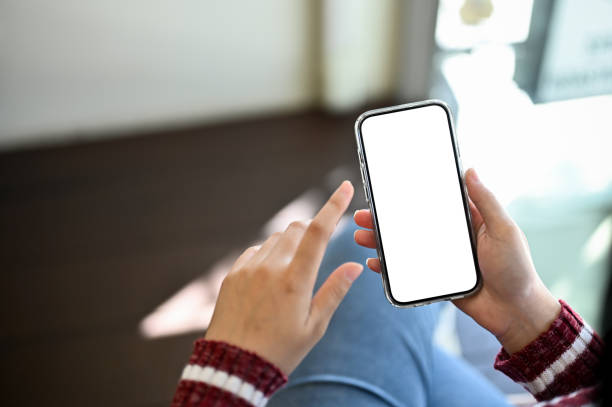 istock A woman using her smartphone. Phone white screen mockup. close-up image 1438278076