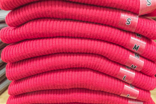 Pile of red knitted crew neck sweaters
