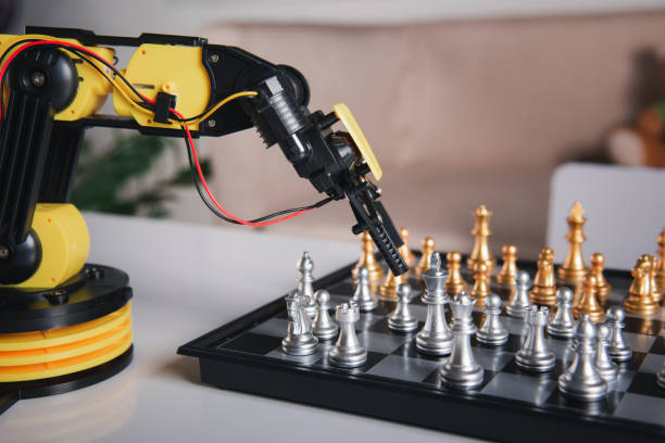 istock Closeup yellow robot arm playing move chess on chessboard 1438280908