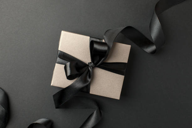 istock Craft gift box on a dark background, decorated with a textured bow, creating a romantic luxury atmosphere. For birthday, anniversary presents, gift post cards, banner, flyer, invitation, voucher 1438281005