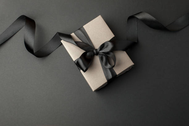 istock Craft gift box on a dark background, decorated with a textured bow, creating a romantic luxury atmosphere. For birthday, anniversary presents, gift post cards, banner, flyer, invitation, voucher 1438281015