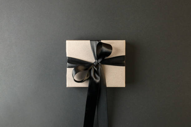 istock Craft gift box on a dark background, decorated with a textured bow, creating a romantic luxury atmosphere. For birthday, anniversary presents, gift post cards, banner, flyer, invitation, voucher 1438281016