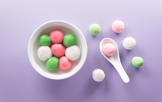 Tang Yuan(sweet dumplings balls), a traditional cuisine for Mid-autumn, Dongzhi (winter solstice ) and Chinese new year on pastel background.