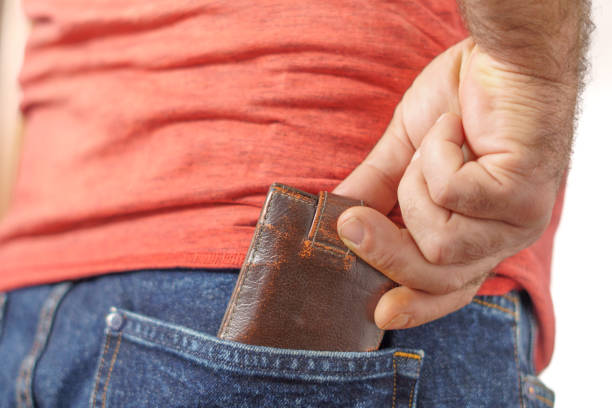 istock man putting his wallet in his trouser pocket 1438282070