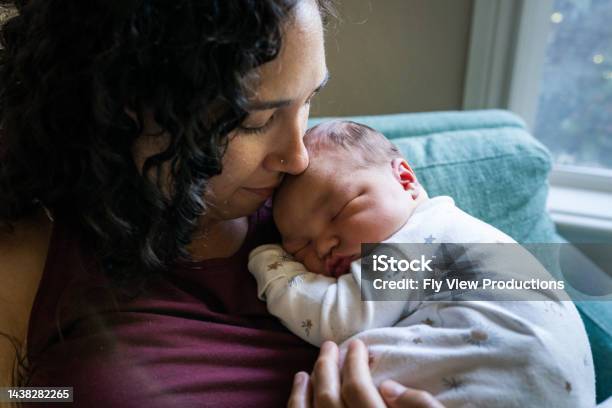 Loving Mom Snuggling Sleeping Newborn Baby Stock Photo - Download Image Now - Baby - Human Age, Newborn, Mother