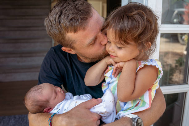 istock Loving father embracing his children 1438282266