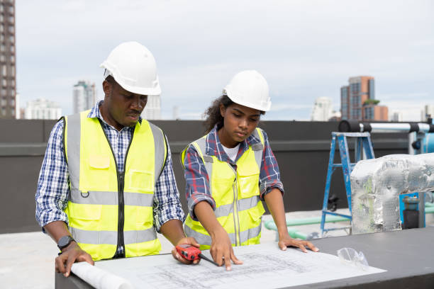 istock Team of African American engineer construction worker working with construction building blueprint at construction site. Group of African American construction worker and building blueprint 1438283628
