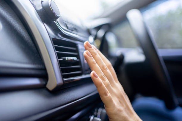 istock Close-up of hands checking car air conditioner, Car cooling system. 1438283633