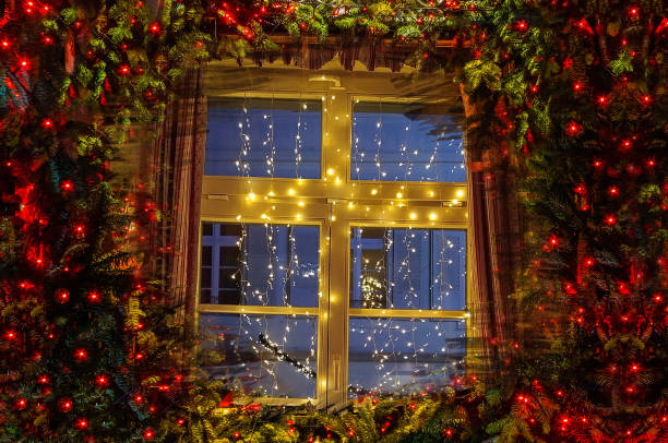 istock Christmas tree and fireplace seen through a wooden cabin window 1438291407