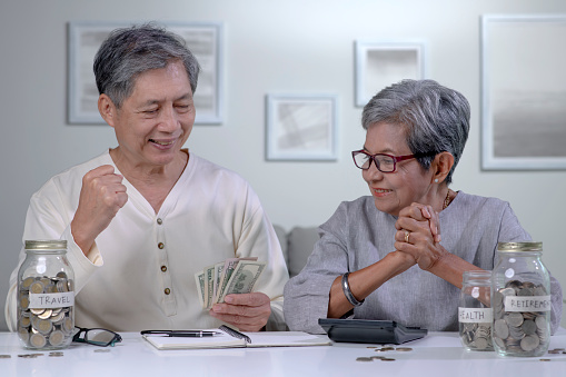 Asian senior couple plans to save money to spend after retirement.