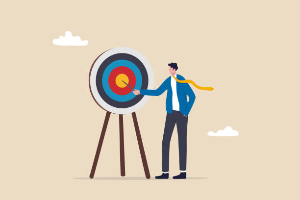 Specific goal, clarify objective or target, focus or concentrate on purpose to win business mission, perfection or aiming at target concept, businessman pointing at center of bullseye archery target. Specific goal, clarify objective or target, focus or concentrate on purpose to win business mission, perfection or aiming at target concept, businessman pointing at center of bullseye archery target. specific stock illustrations