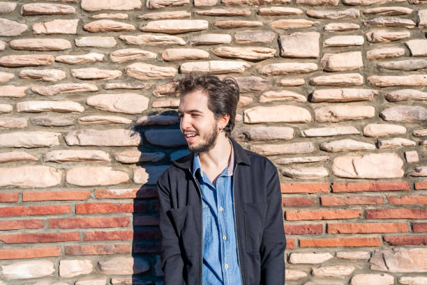 istock Portrait of a man with stone wall background 1438294851