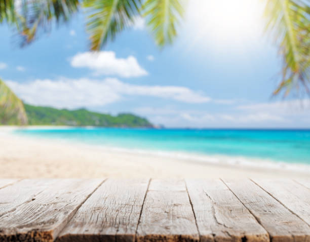 istock Empty wooden table or pier with sunny beach and sea 1438297340