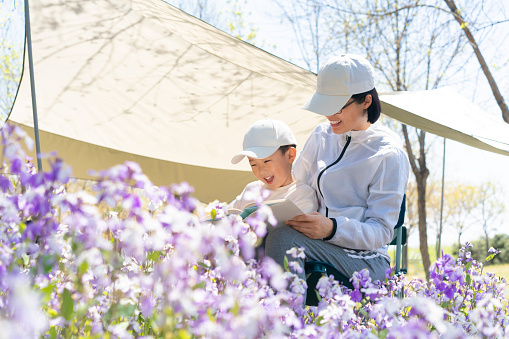 Mom and baby read together in park