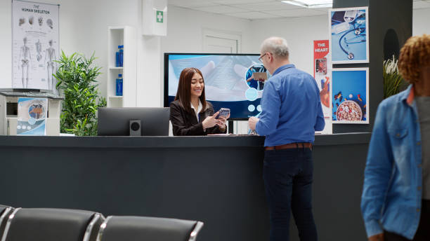 istock Senior patient paying medical consultation at facility reception counter 1438300065