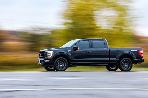 dundas, Canada – October 27, 2022: A black Ford F150 on a road against blur background
