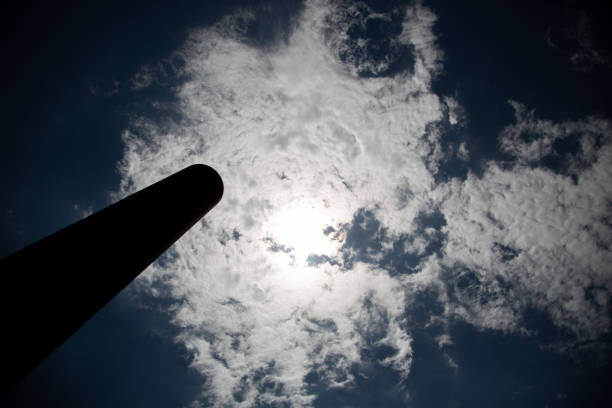 A low angle shot of a tower under cloudy sky