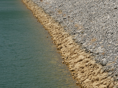 A high angle shot of stony shore in the sea