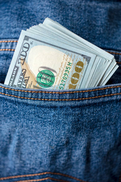 istock Dollar bills in jeans pocket 1438302265