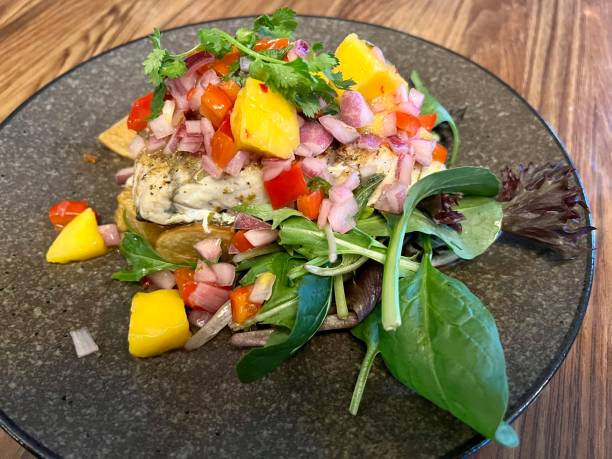 istock Barramundi with Green Leaves and Mango Salsa 1438305858