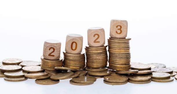 istock Blocks with number 2023 on stack of coins 1438305868